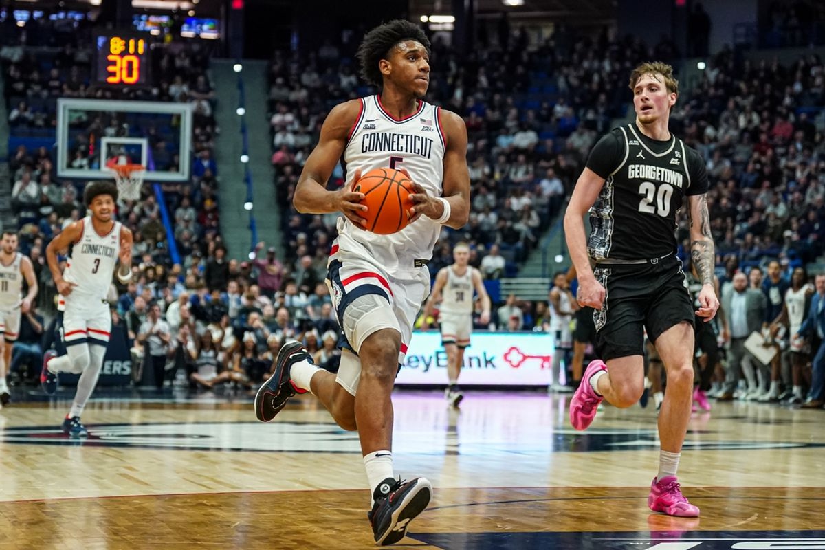 Feb 26, 2025; Hartford, Connecticut, USA; UConn Huskies center Tarris Reed Jr. (5) drives the ball to the basket against Georgetown Hoyas forward Drew Fielder (20) in the first half at XL Center. Mandatory Credit: David Butler II-Imagn Images