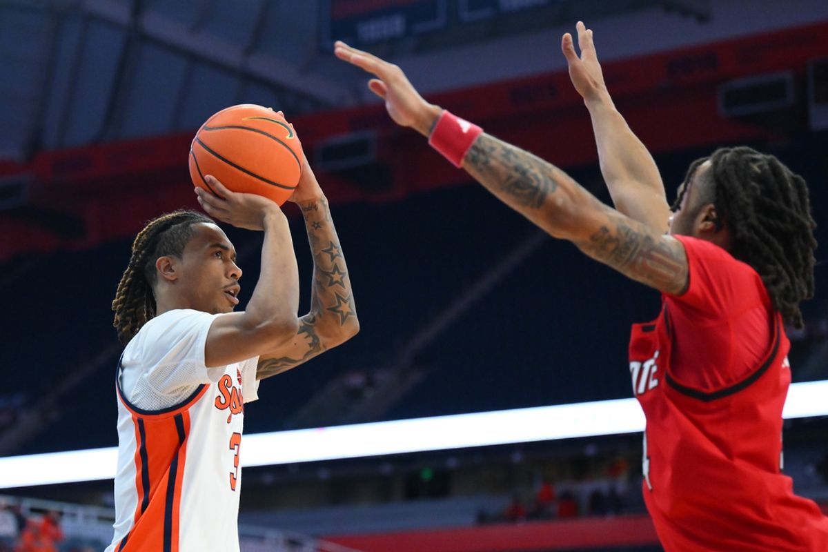 Feb 26, 2025; Syracuse, New York, USA; Syracuse Orange guard Lucas Taylor (3) shoots against North Carolina State Wolfpack guard Breon Pass (4) during the first half at the JMA Wireless Dome. Mandatory Credit: Rich Barnes-Imagn Images
