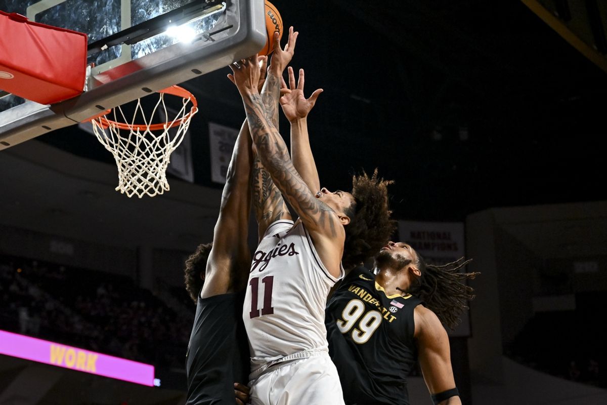 Feb 26, 2025; College Station, Texas, USA; Texas A&M Aggies forward Andersson Garcia (11) shoots the ball as Vanderbilt Commodores forward Devin McGlockton (99) defends during the first half at Reed Arena. Mandatory Credit: Maria Lysaker-Imagn Images