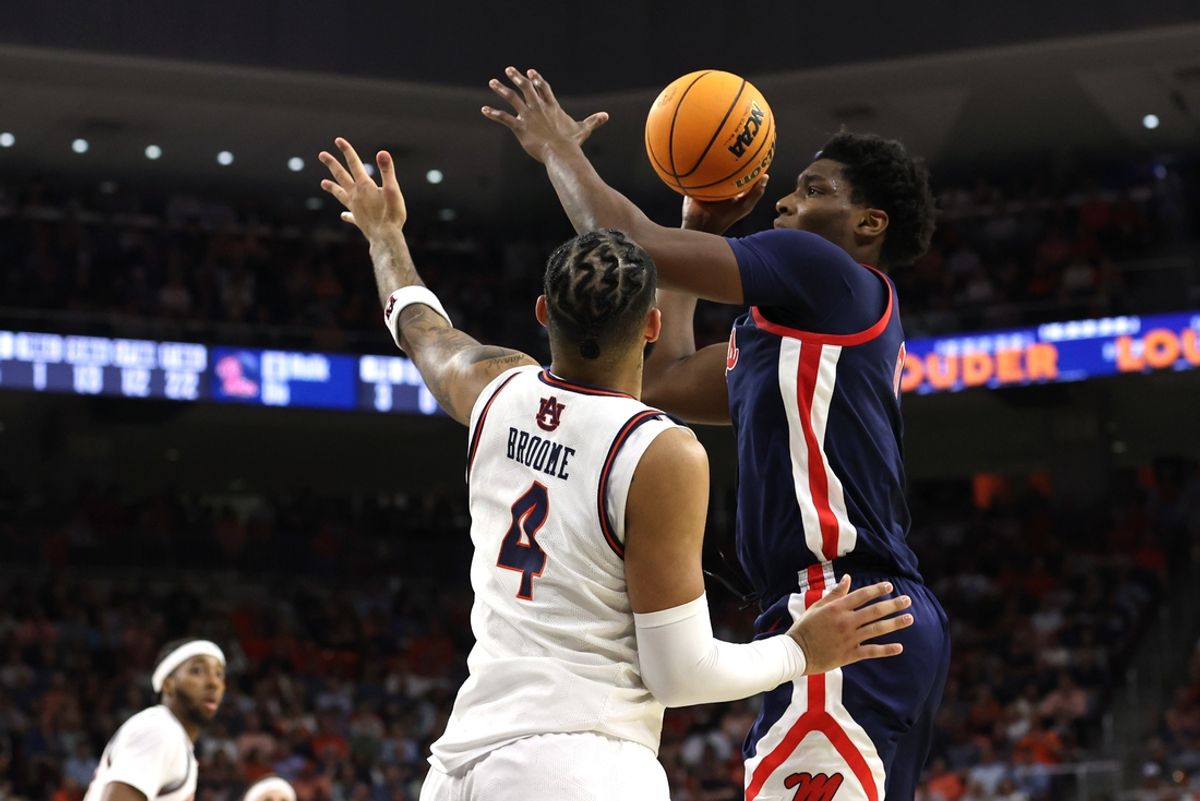 Feb 26, 2025; Auburn, Alabama, USA;  Mississippi Rebels forward Malik Dia (0) takes a shot over Auburn Tigers forward Johni Broome (4) during the first half at Neville Arena. Mandatory Credit: John Reed-Imagn Images