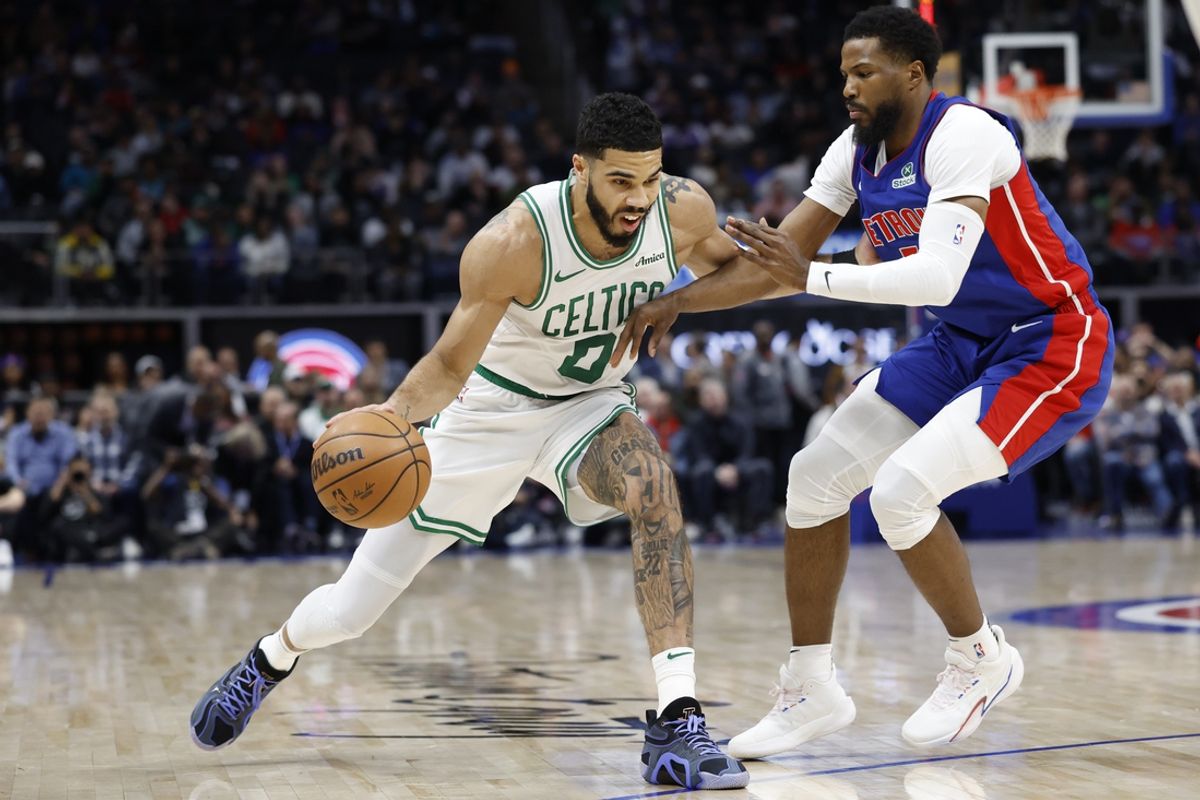 Feb 26, 2025; Detroit, Michigan, USA;  Boston Celtics forward Jayson Tatum (0) dribbles defended by Detroit Pistons guard Malik Beasley (5) in the first half at Little Caesars Arena. Mandatory Credit: Rick Osentoski-Imagn Images