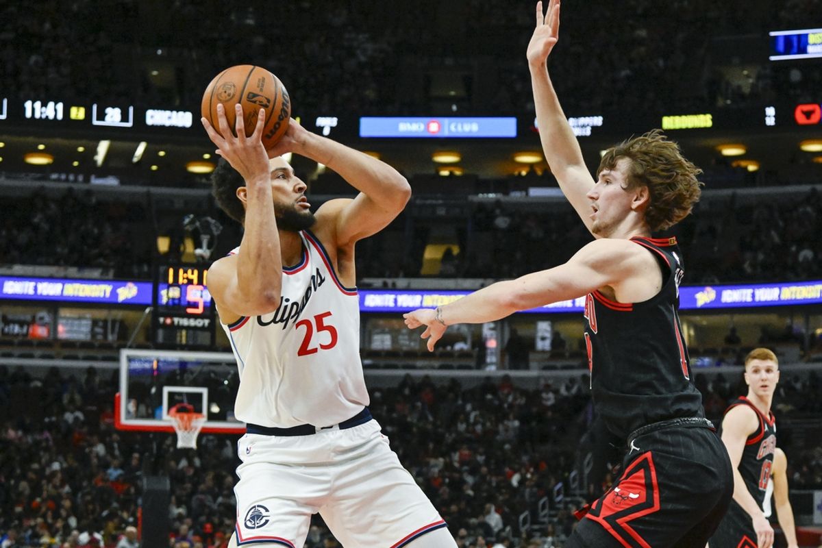 Feb 26, 2025; Chicago, Illinois, USA;  LA Clippers guard Ben Simmons (25) passes the ball against Chicago Bulls forward Matas Buzelis (14) during the first half at the United Center. Mandatory Credit: Matt Marton-Imagn Images