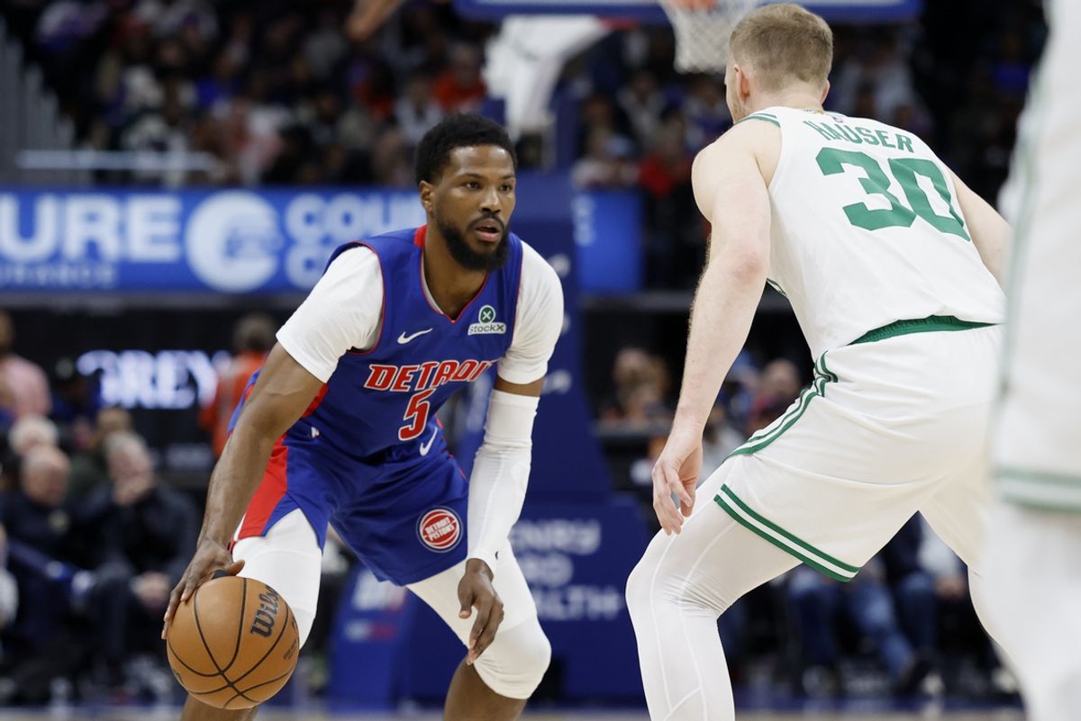 Feb 26, 2025; Detroit, Michigan, USA;  Detroit Pistons guard Malik Beasley (5) dribbles while being defended by Boston Celtics forward Sam Hauser (30) in the second half at Little Caesars Arena. Mandatory Credit: Rick Osentoski-Imagn Images