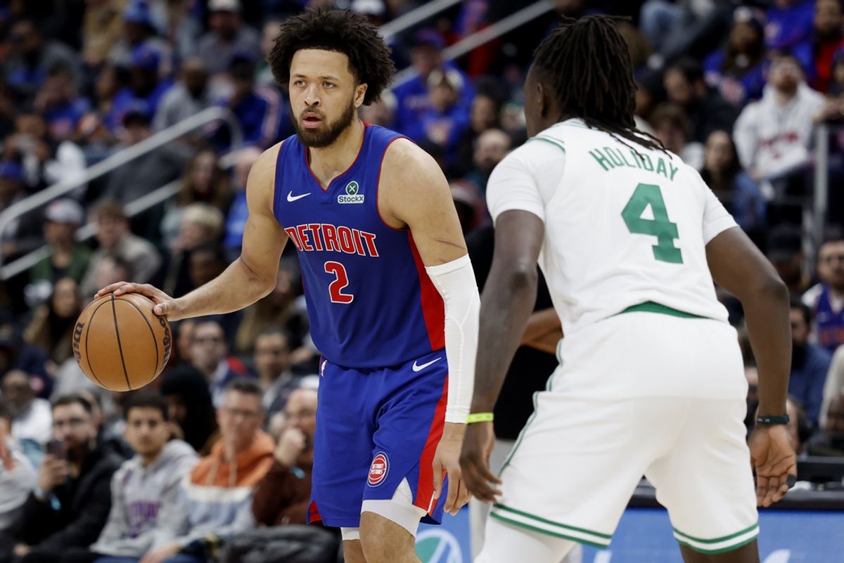 Feb 26, 2025; Detroit, Michigan, USA;  Detroit Pistons guard Cade Cunningham (2) defended by Boston Celtics guard Jrue Holiday (4) in the second half at Little Caesars Arena. Mandatory Credit: Rick Osentoski-Imagn Images