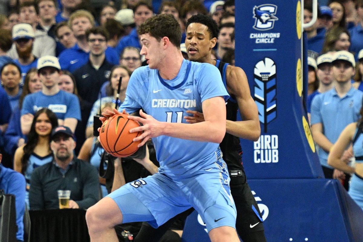 Feb 26, 2025; Omaha, Nebraska, USA;  Creighton Bluejays center Ryan Kalkbrenner (11) drives against DePaul Blue Demons forward JJ Traynor (20) during the first half at CHI Health Center Omaha. Mandatory Credit: Steven Branscombe-Imagn Images