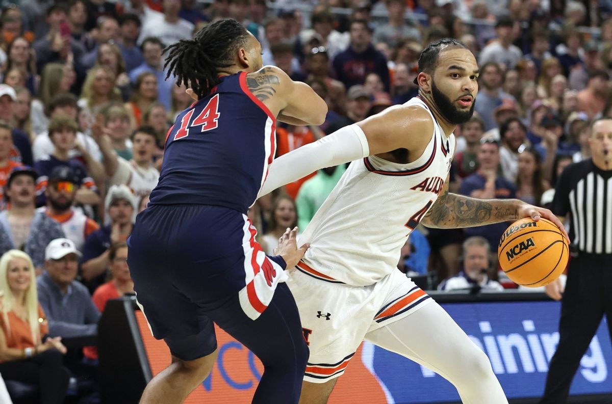 Feb 26, 2025; Auburn, Alabama, USA;  Auburn Tigers center Johni Broome (4) goes for a shot as Mississippi Rebels guard Dre Davis (14) defends during the second half at Neville Arena. Mandatory Credit: John Reed-Imagn Images