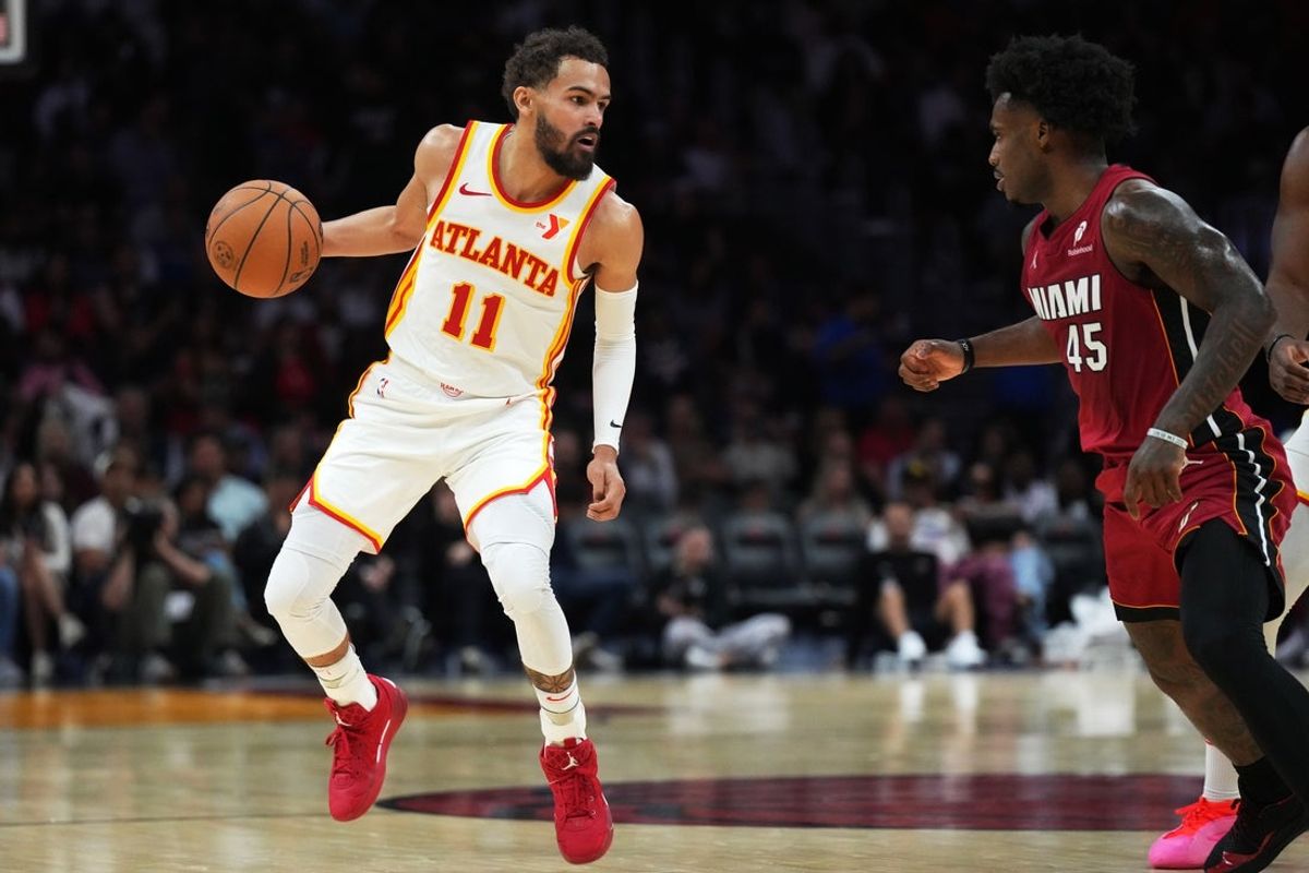 Feb 26, 2025; Miami, Florida, USA;  Atlanta Hawks guard Trae Young (11) brings the ball up the court as Miami Heat guard Davion Mitchell (45) defends in the second half at Kaseya Center. Mandatory Credit: Jim Rassol-Imagn Images
