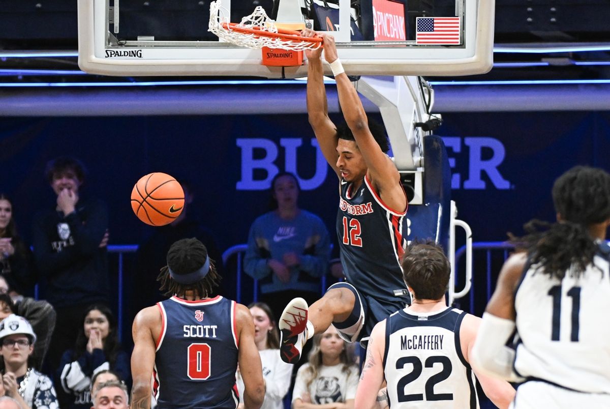 Feb 26, 2025; Indianapolis, Indiana, USA; St. John's Red Storm guard RJ Luis Jr. (12) dunks the ball past Butler Bulldogs forward Patrick McCaffery (22) during the first half at Hinkle Fieldhouse. Mandatory Credit: Robert Goddin-Imagn Images