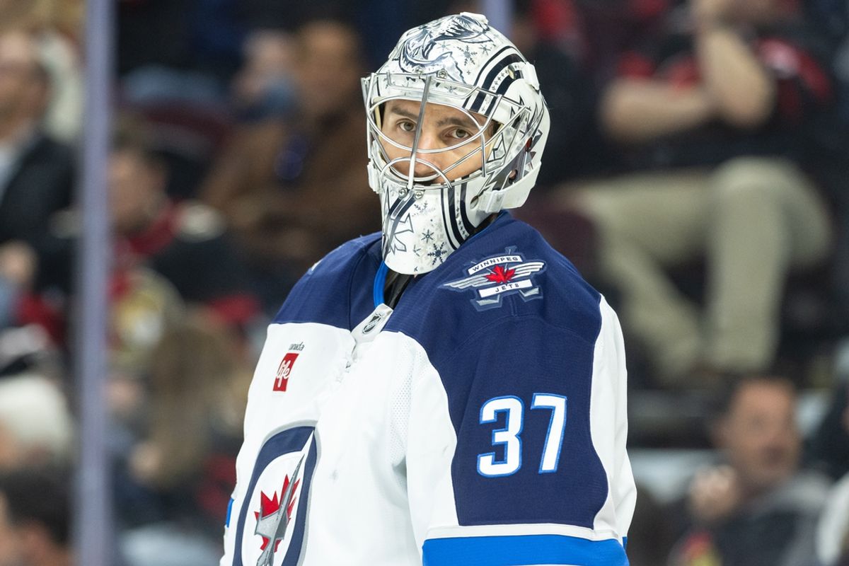 Feb 26, 2025; Ottawa, Ontario, CAN; Winnipeg Jets goalie Connor Hellebuyck (37) glances over during a break in the first period against the Ottawa Senators at the Canadian Tire Centre. Mandatory Credit: Marc DesRosiers-Imagn Images