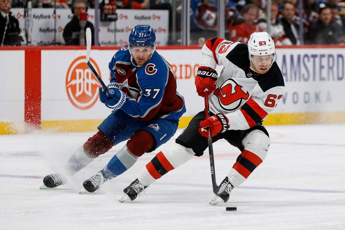 Feb 26, 2025; Denver, Colorado, USA; New Jersey Devils left wing Jesper Bratt (63) controls the puck ahead of Colorado Avalanche center Casey Mittelstadt (37) in the second period at Ball Arena. Mandatory Credit: Isaiah J. Downing-Imagn Images