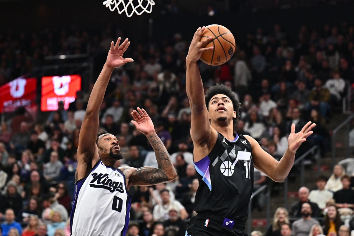 Feb 26, 2025; Salt Lake City, Utah, USA;  Utah Jazz guard Jaden Springer (11) drives past Sacramento Kings guard Malik Monk (0) for a lay up in the second half at Delta Center. Mandatory Credit: Jamie Sabau-Imagn Images