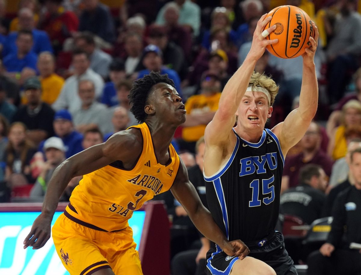 Feb 26, 2025; Tempe, Arizona, USA; Brigham Young Cougars forward Richie Saunders (15) drives against Arizona State Sun Devils guard Joson Sanon (3) during the second half at Desert Financial Arena. Mandatory Credit: Joe Camporeale-Imagn Images