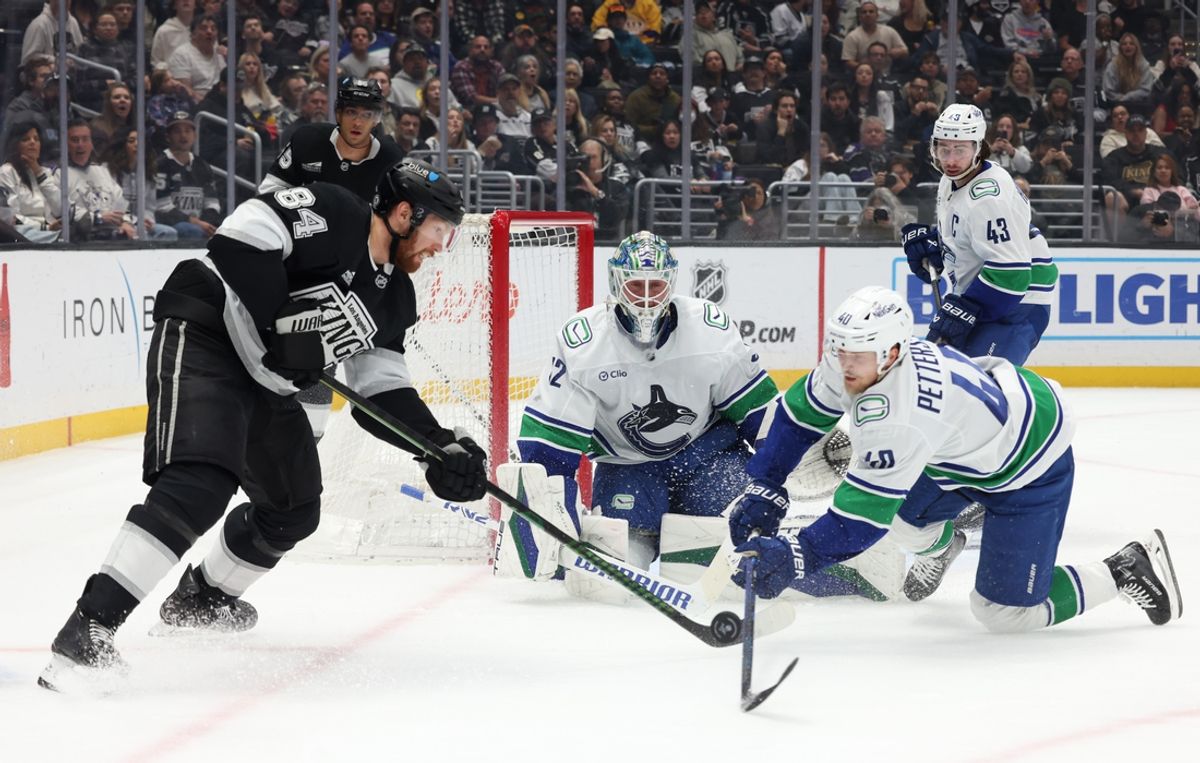 Feb 26, 2025; Los Angeles, California, USA; Vancouver Canucks goaltender Kevin Lankinen (32) and center Elias Pettersson (40) defend the goal against Los Angeles Kings defenseman Vladislav Gavrikov (84) during the second period at Crypto.com Arena. Mandatory Credit: Jason Parkhurst-Imagn Images