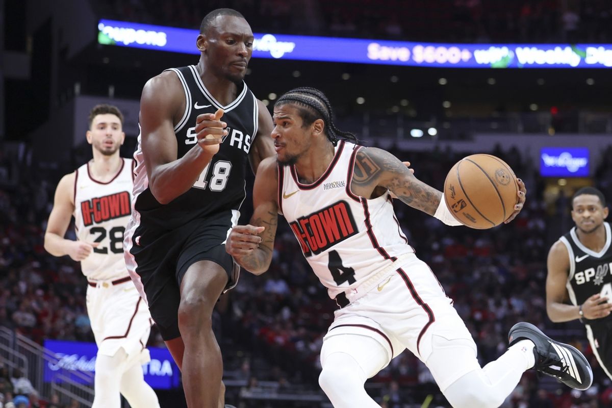 Feb 26, 2025; Houston, Texas, USA; Houston Rockets guard Jalen Green (4) drives with the ball as San Antonio Spurs center Bismack Biyombo (18) defends during the third quarter at Toyota Center. Mandatory Credit: Troy Taormina-Imagn Images