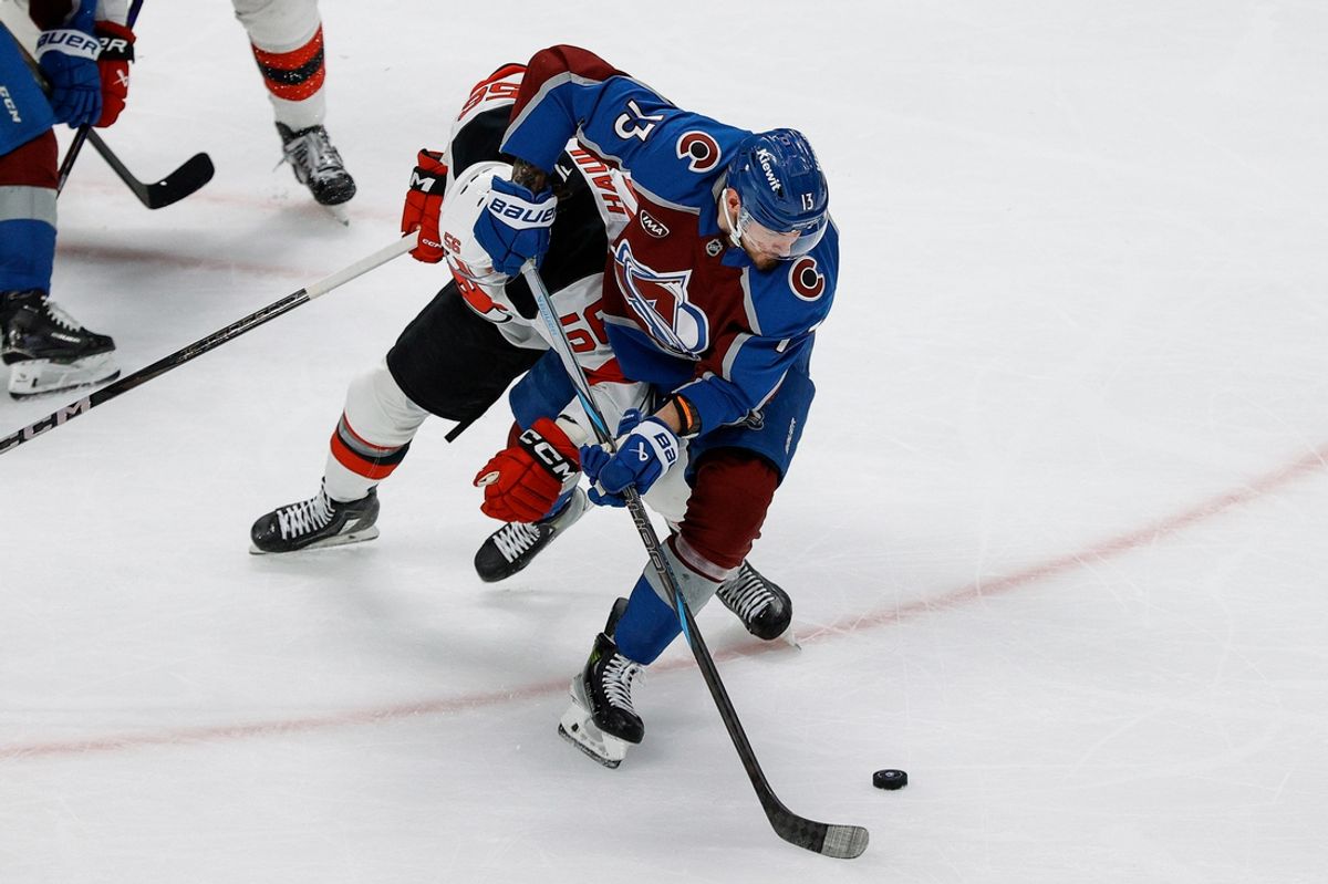 Feb 26, 2025; Denver, Colorado, USA; Colorado Avalanche right wing Valeri Nichushkin (13) and New Jersey Devils left wing Erik Haula (56) battle for the puck in the third period at Ball Arena. Mandatory Credit: Isaiah J. Downing-Imagn Images