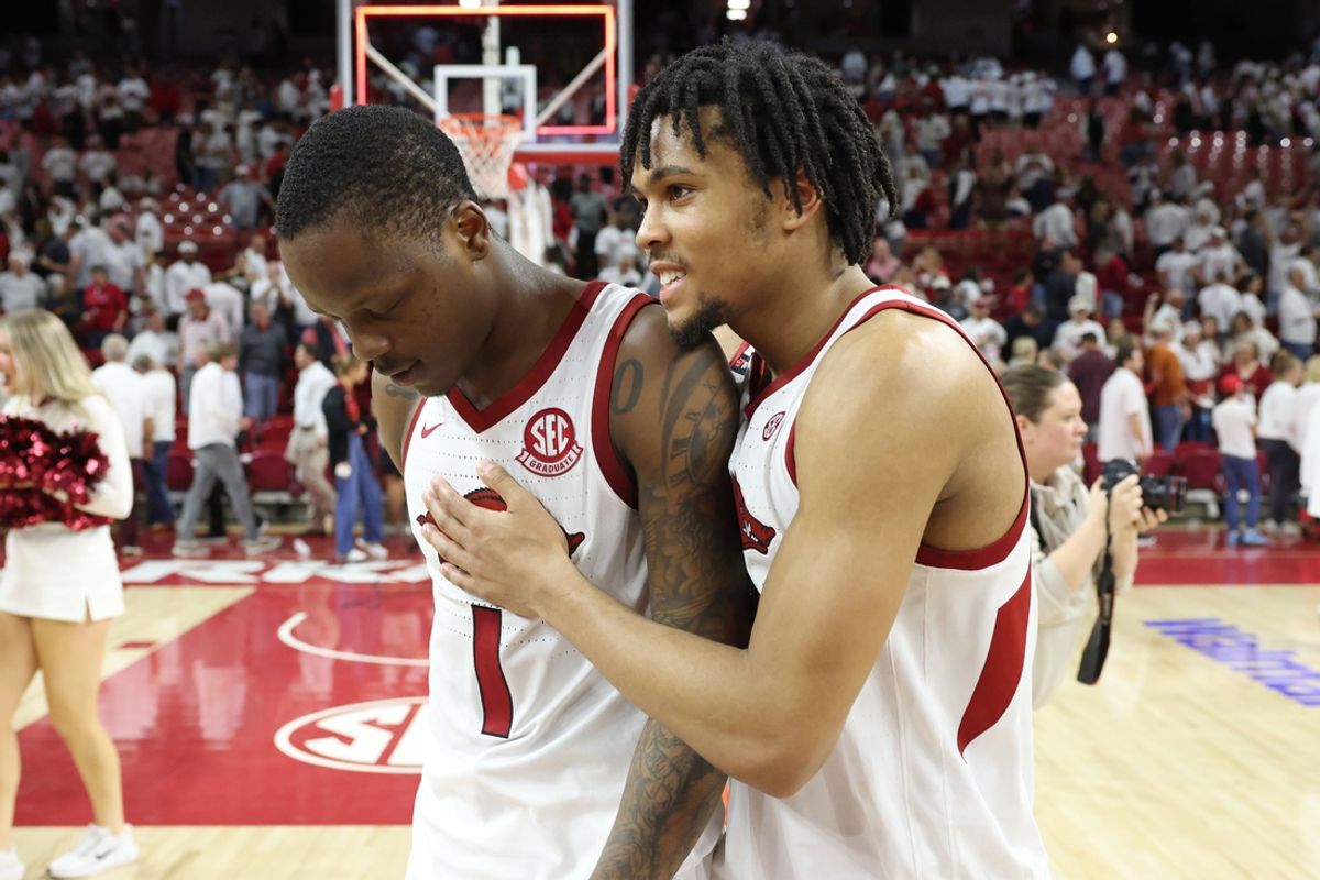 Feb 26, 2025; Fayetteville, Arkansas, USA; Arkansas Razorbacks guards Johnell Davis (1) and D.J. Wagner (21) celebrate after an overtime win against the Texas Longhorns at Bud Walton Arena. Mandatory Credit: Nelson Chenault-Imagn Images