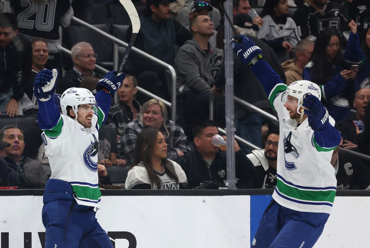 Feb 26, 2025; Los Angeles, California, USA; Vancouver Canucks right wing Conor Garland (8) celebrates with defenseman Marcus Pettersson (29) after a game-winning goal during overtime against the Los Angeles Kings at Crypto.com Arena. Mandatory Credit: Jason Parkhurst-Imagn Images