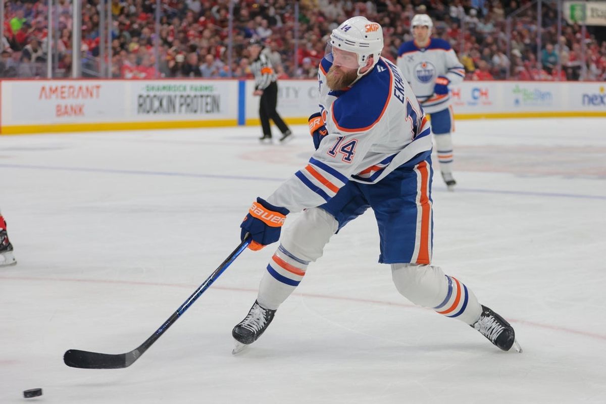 Feb 27, 2025; Sunrise, Florida, USA; Edmonton Oilers defenseman Mattias Ekholm (14) shoots the puck against the Florida Panthers during the first period at Amerant Bank Arena. Mandatory Credit: Sam Navarro-Imagn Images