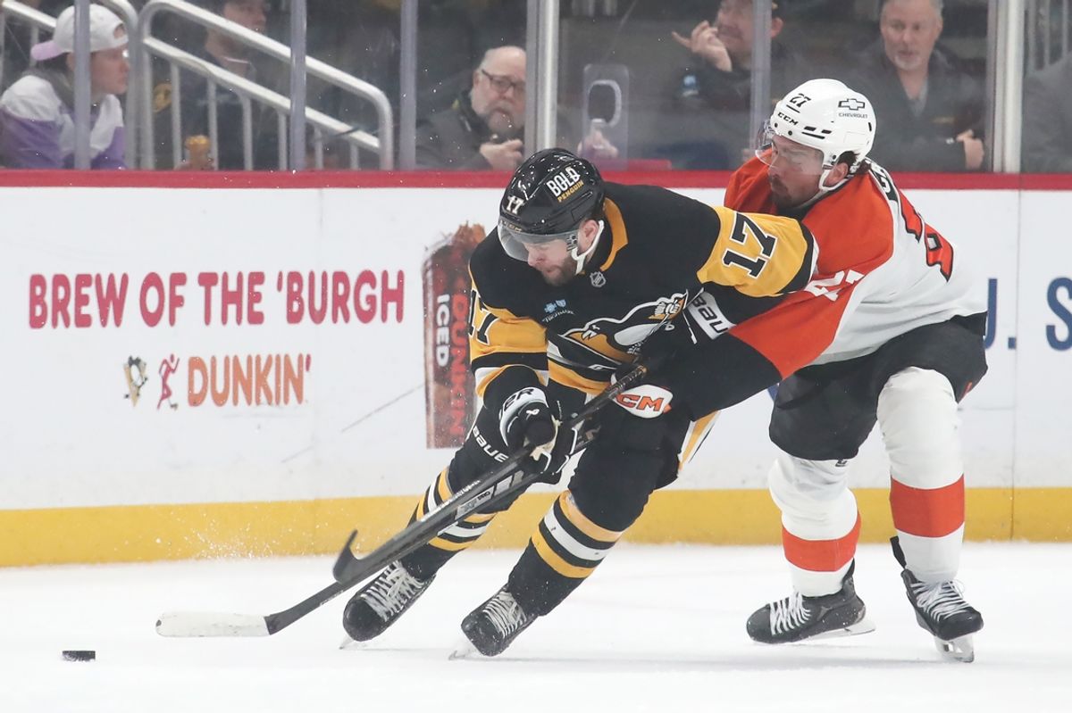 Feb 27, 2025; Pittsburgh, Pennsylvania, USA;  Pittsburgh Penguins right wing Bryan Rust (17) moves the puck against Philadelphia Flyers left wing Noah Cates (27) during the first period at PPG Paints Arena. Mandatory Credit: Charles LeClaire-Imagn Images