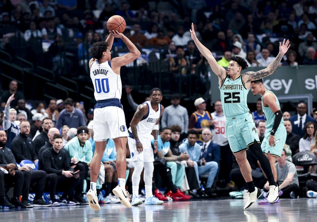 Feb 27, 2025; Dallas, Texas, USA;  Dallas Mavericks guard Max Christie (00) shoots over Charlotte Hornets guard KJ Simpson (25) during the first half at American Airlines Center. Mandatory Credit: Kevin Jairaj-Imagn Images