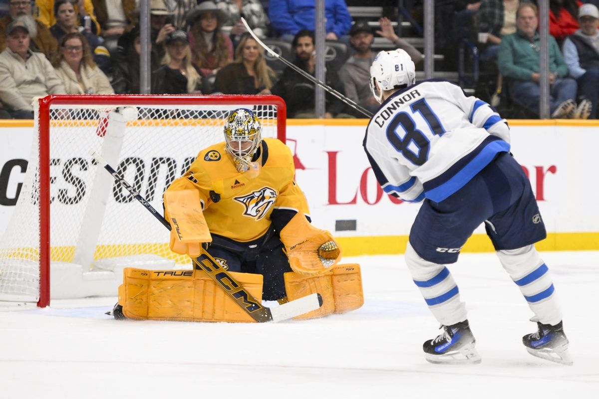 Feb 27, 2025; Nashville, Tennessee, USA;  Nashville Predators goaltender Juuse Saros (74) blocks the shot of Winnipeg Jets left wing Kyle Connor (81) during the first period at Bridgestone Arena. Mandatory Credit: Steve Roberts-Imagn Images
