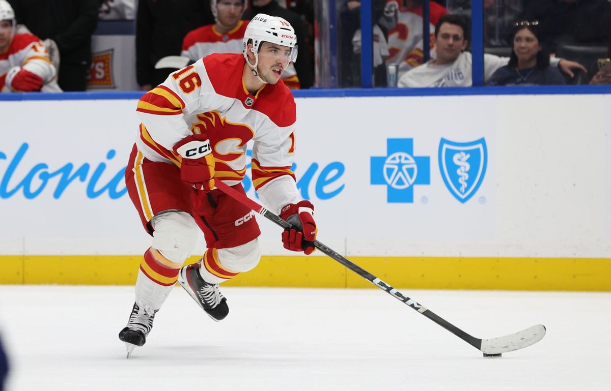 Feb 27, 2025; Tampa, Florida, USA; Calgary Flames center Morgan Frost (16) skates with the puck against the Tampa Bay Lightning during the second period at Amalie Arena. Mandatory Credit: Kim Klement Neitzel-Imagn Images
