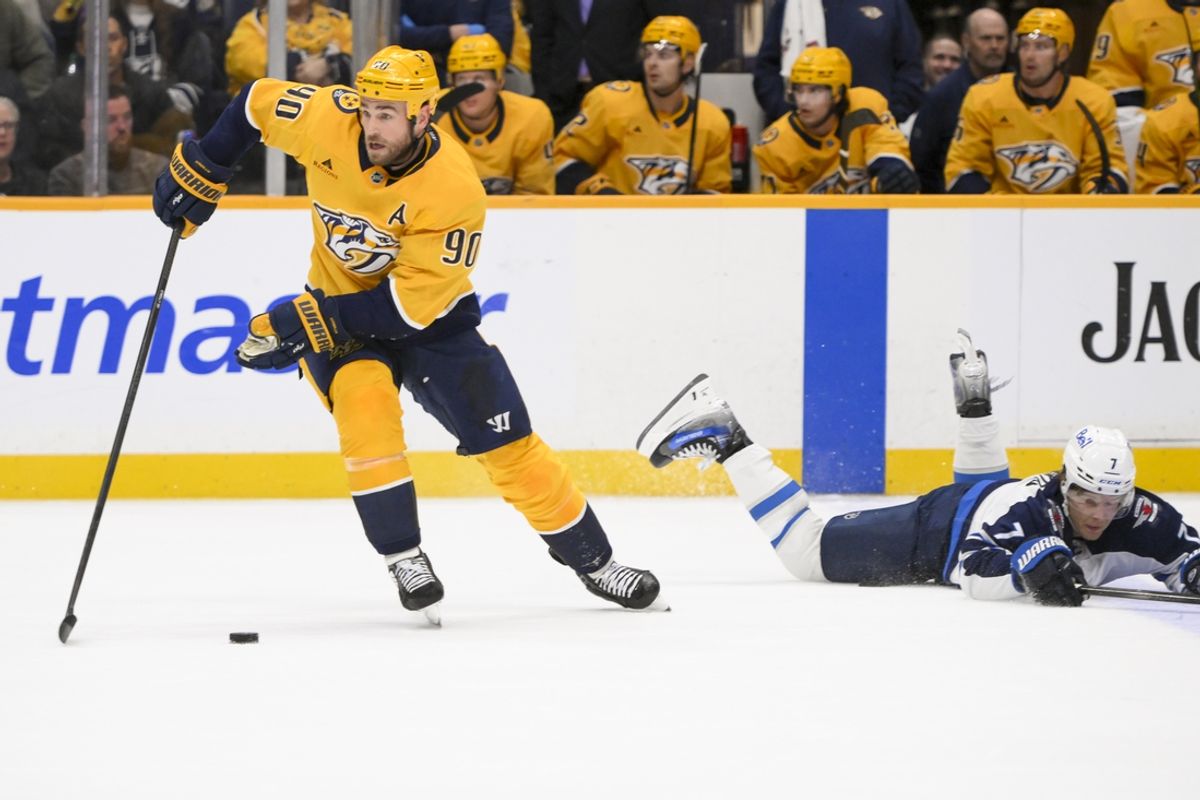Feb 27, 2025; Nashville, Tennessee, USA;  Nashville Predators center Ryan O'Reilly (90) steals the puck from Winnipeg Jets center Vladislav Namestnikov (7) during the second period at Bridgestone Arena. Mandatory Credit: Steve Roberts-Imagn Images