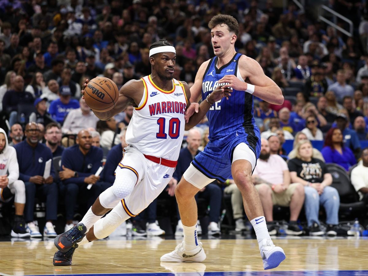 Feb 27, 2025; Orlando, Florida, USA; Golden State Warriors forward Jimmy Butler III (10) is guarded by Orlando Magic forward Franz Wagner (22) in the fourth quarter at Kia Center. Mandatory Credit: Nathan Ray Seebeck-Imagn Images