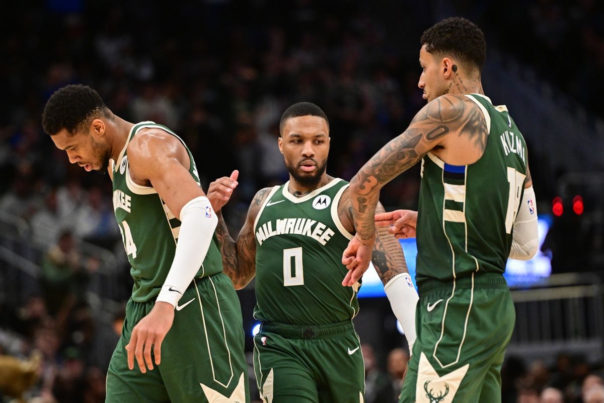 Feb 27, 2025; Milwaukee, Wisconsin, USA;  Milwaukee Bucks guard Damian Lillard (0) celebrates a three-point basket with forward Giannis Antetokounmpo (34) and forward Kyle Kuzma (18) in the fourth quarter against the Denver Nuggets at Fiserv Forum. Mandatory Credit: Benny Sieu-Imagn Images