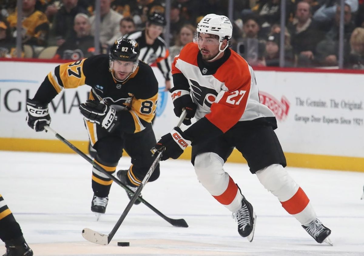 Feb 27, 2025; Pittsburgh, Pennsylvania, USA;  Philadelphia Flyers left wing Noah Cates (27) moves the puck ahed of Pittsburgh Penguins center Sidney Crosby (87) during the second period at PPG Paints Arena. Mandatory Credit: Charles LeClaire-Imagn Images