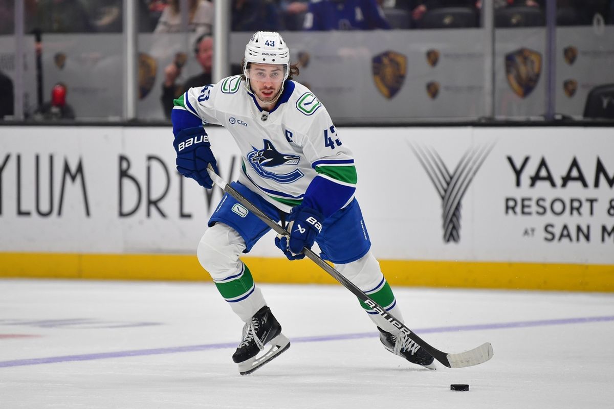 Vancouver Canucks defenseman Quinn Hughes (43) moves the puck against the Anaheim Ducks during the first period at Honda Center.