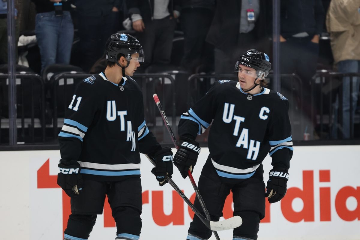 Feb 27, 2025; Salt Lake City, Utah, USA; Utah Hockey Club right wing Dylan Guenther (11) and center Clayton Keller (9) reacts to a goal against the Minnesota Wild during the first period at Delta Center. Mandatory Credit: Rob Gray-Imagn Images