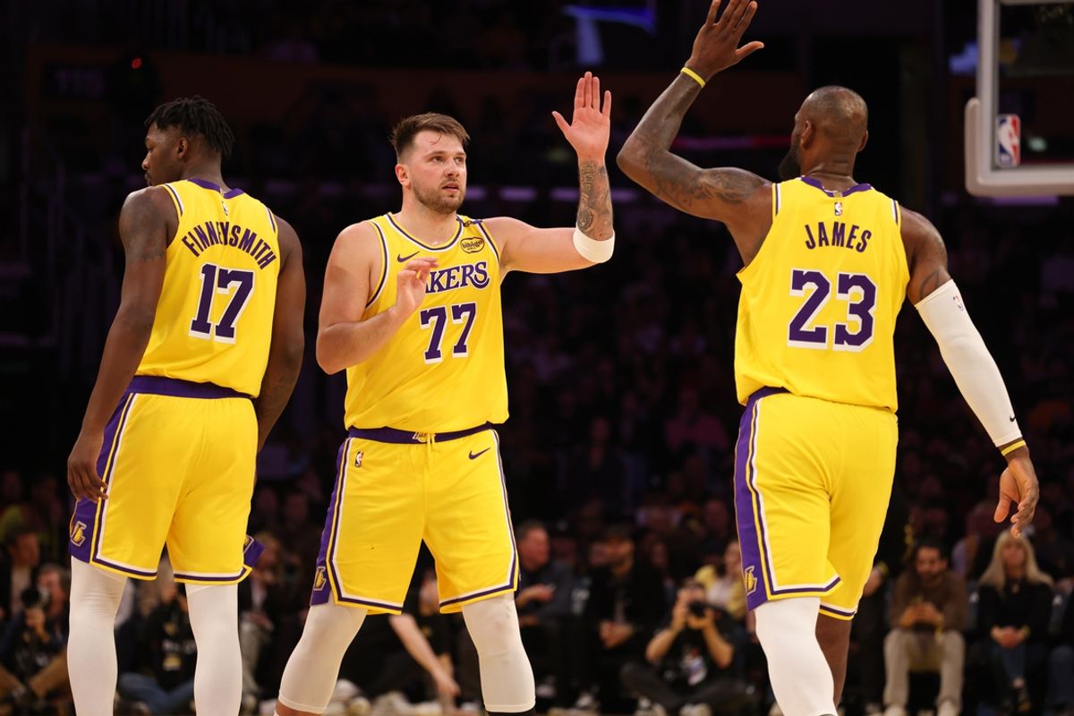 Feb 27, 2025; Los Angeles, California, USA; Los Angeles Lakers forward LeBron James (23) and guard Luka Doncic (77) react after a play during the first quarter against the Minnesota Timberwolves at Crypto.com Arena. Mandatory Credit: Jason Parkhurst-Imagn Images