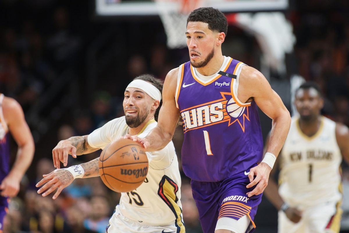 Feb 27, 2025; Phoenix, Arizona, USA; New Orleans Pelicans guard Jose Alvarado (15) steals the ball from Phoenix Suns guard Devin Booker (1) in the fourth quarter at Footprint Center. Mandatory Credit: Brett Davis-Imagn Images