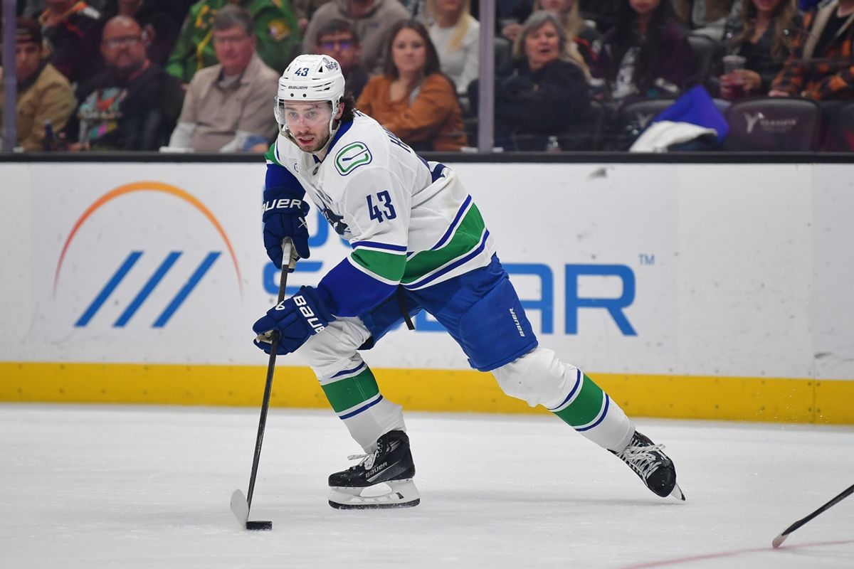 Vancouver Canucks defenseman Quinn Hughes (43) controls the puck against the Anaheim Ducks during the third period at Honda Center. Mandatory Credit: Gary A. Vasquez-Imagn Images