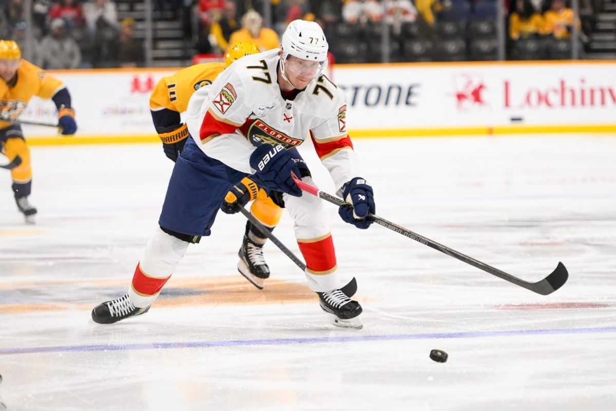 Feb 25, 2025; Nashville, Tennessee, USA;  Florida Panthers defenseman Niko Mikkola (77) skates with the puck against the Nashville Predators during the second period at Bridgestone Arena. Mandatory Credit: Steve Roberts-Imagn Images