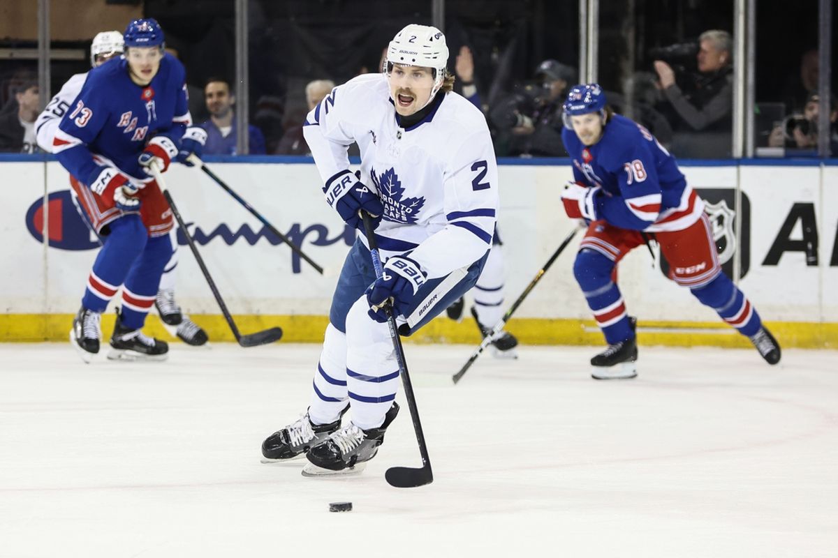 Feb 28, 2025; New York, New York, USA;  Toronto Maple Leafs defenseman Simon Benoit (2) looks for an open teammate in the first period against the New York Rangers at Madison Square Garden. Mandatory Credit: Wendell Cruz-Imagn Images