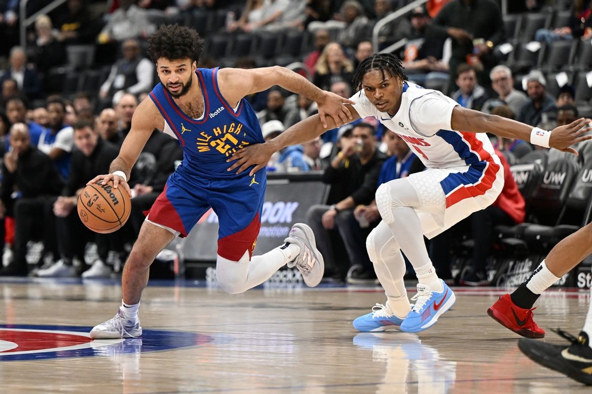 Feb 28, 2025; Detroit, Michigan, USA;  Denver Nuggets guard Jamal Murray (27) drives past Detroit Pistons forward Ausar Thompson (9) in the first quarter at Little Caesars Arena. Mandatory Credit: Lon Horwedel-Imagn Images