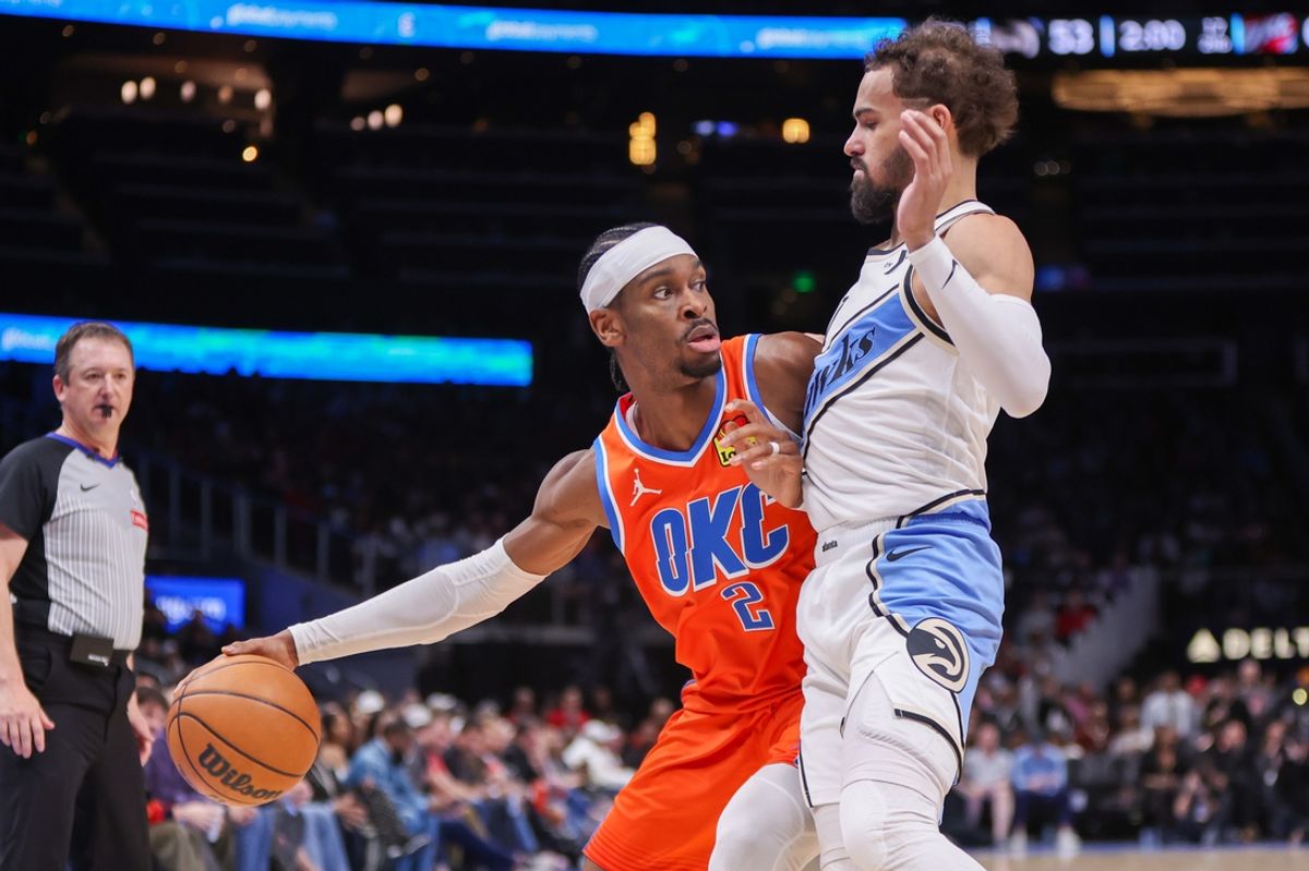 Feb 28, 2025; Atlanta, Georgia, USA; Oklahoma City Thunder guard Shai Gilgeous-Alexander (2) is defended by Atlanta Hawks guard Trae Young (11) in the second quarter at State Farm Arena. Mandatory Credit: Brett Davis-Imagn Images