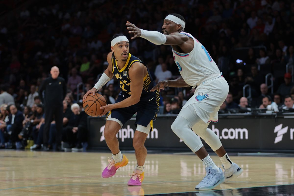 Feb 28, 2025; Miami, Florida, USA; Indiana Pacers guard Andrew Nembhard (2) protects the basketball from Miami Heat center Bam Adebayo (13) during the second quarter at Kaseya Center. Mandatory Credit: Sam Navarro-Imagn Images