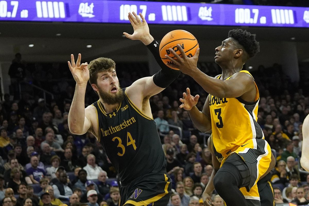 Feb 28, 2025; Evanston, Illinois, USA; Northwestern Wildcats center Matthew Nicholson (34) defends Iowa Hawkeyes guard Drew Thelwell (3) during the first half at Welsh-Ryan Arena. Mandatory Credit: David Banks-Imagn Images