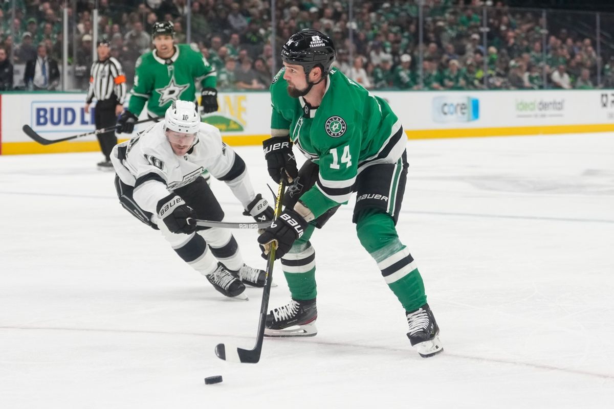 Feb 28, 2025; Dallas, Texas, USA; Dallas Stars left wing Jamie Benn (14) looks to pass the puck as Los Angeles Kings left wing Tanner Jeannot (10) defends during the second period at American Airlines Center. Mandatory Credit: Chris Jones-Imagn Images