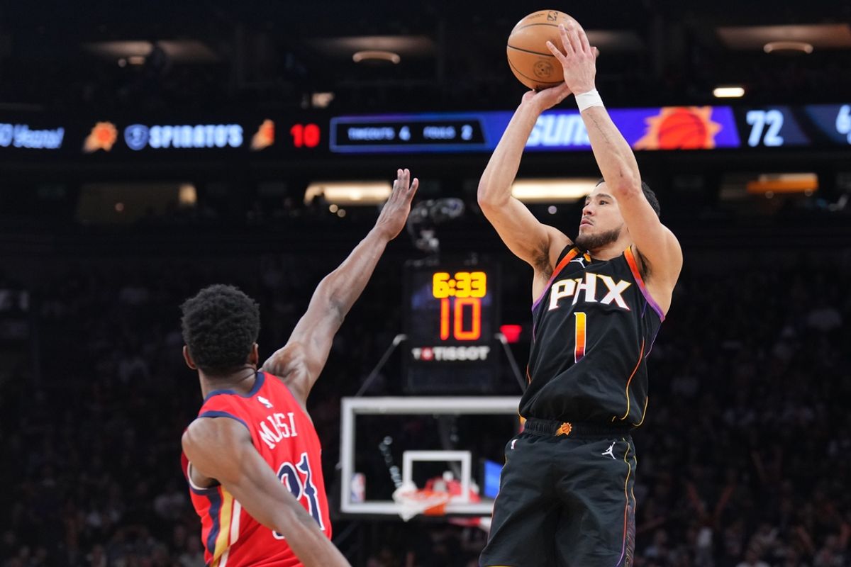 Feb 28, 2025; Phoenix, Arizona, USA; Phoenix Suns guard Devin Booker (1) shoots against New Orleans Pelicans center Yves Missi (21) during the second half at Footprint Center. Mandatory Credit: Joe Camporeale-Imagn Images