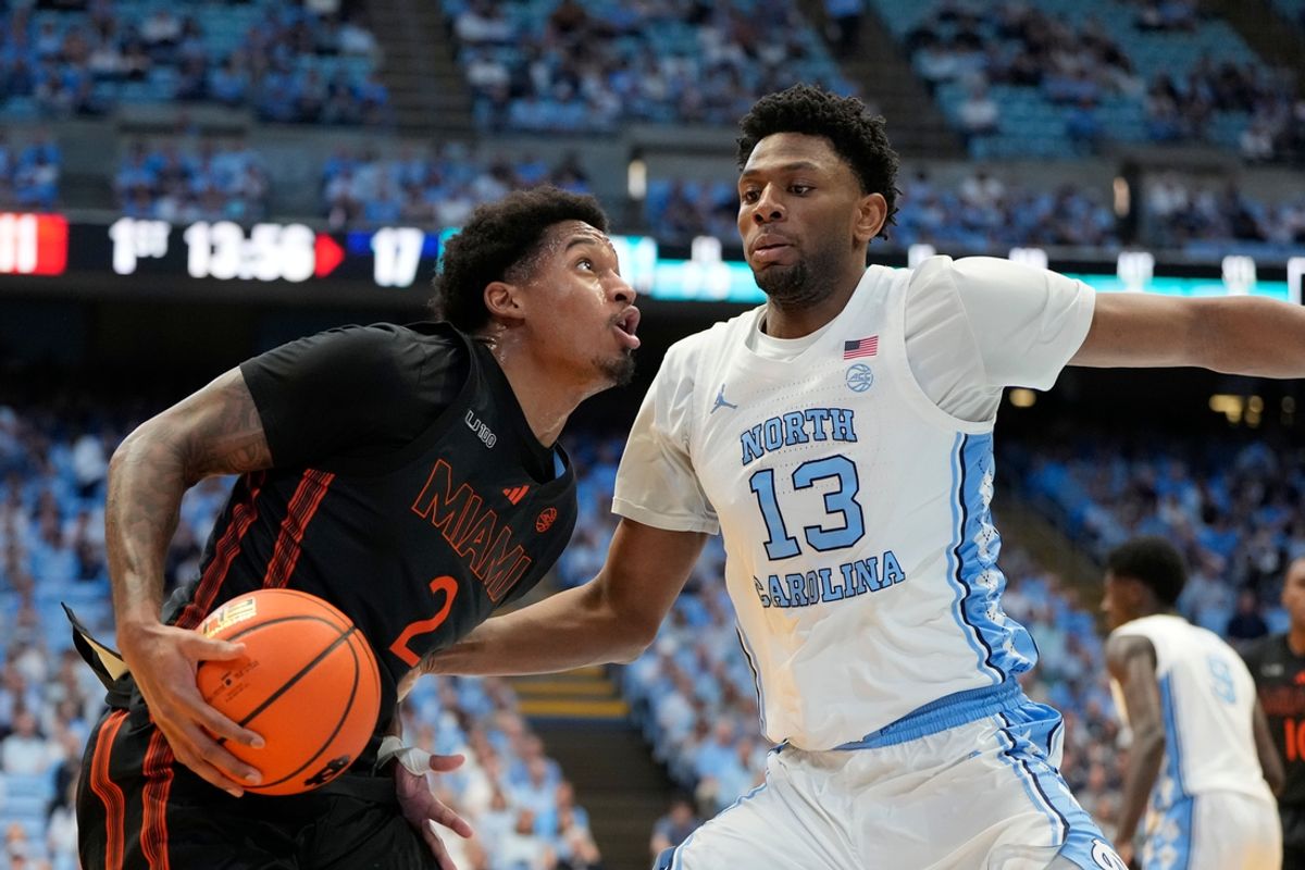 Mar 1, 2025; Chapel Hill, North Carolina, USA;  Miami (Fl) Hurricanes forward Brandon Johnson (2) with the ball as North Carolina Tar Heels forward Jalen Washington (13) defends in the first half at Dean E. Smith Center. Mandatory Credit: Bob Donnan-Imagn Images