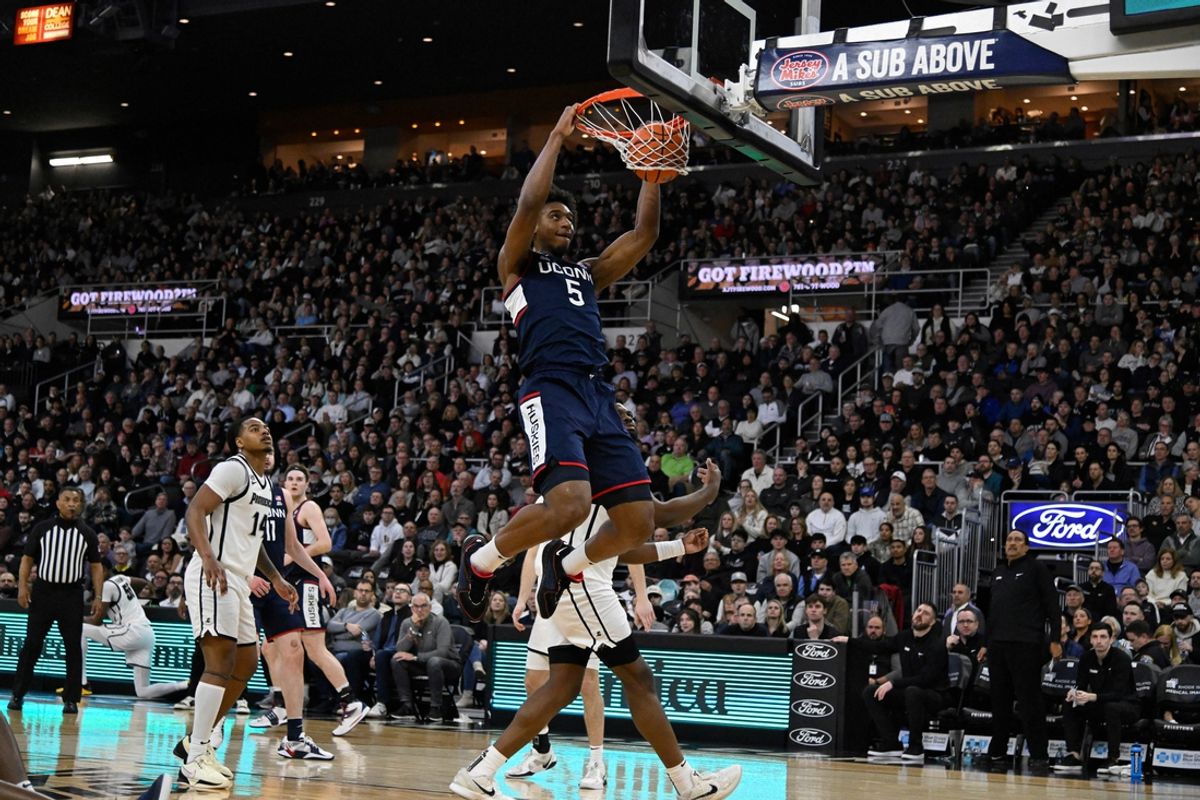 Mar 1, 2025; Providence, Rhode Island, USA; Connecticut Huskies center Tarris Reed Jr. (5)  dunks the ball against the Providence Friars during the first half at Amica Mutual Pavilion. Mandatory Credit: Eric Canha-Imagn Images