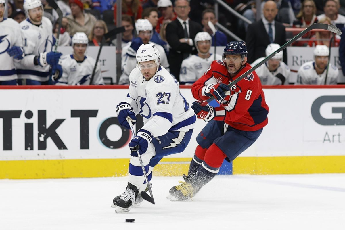 Mar 1, 2025; Washington, District of Columbia, USA; Tampa Bay Lightning defenseman Ryan McDonagh (27) skates with the puck as Washington Capitals left wing Alex Ovechkin (8) defends in the first period at Capital One Arena. Mandatory Credit: Geoff Burke-Imagn Images