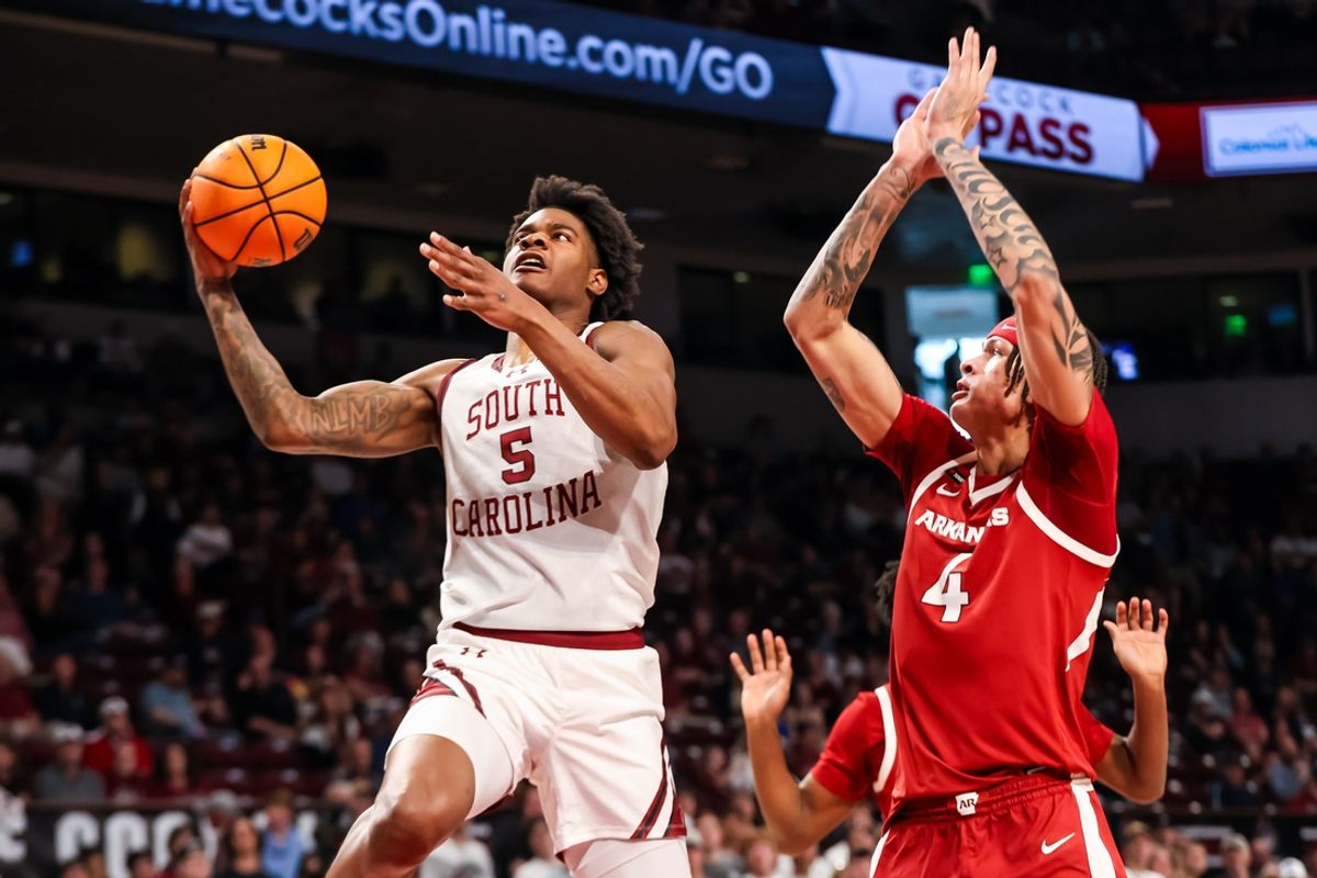 Mar 1, 2025; Columbia, South Carolina, USA; South Carolina Gamecocks forward Nick Pringle (5) drives past Arkansas Razorbacks forward Trevon Brazile (4) in the first half at Colonial Life Arena. Mandatory Credit: Jeff Blake-Imagn Images