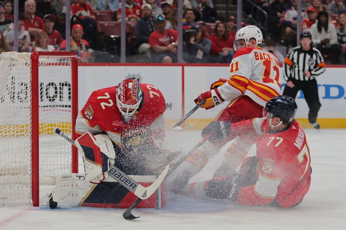 Mar 1, 2025; Sunrise, Florida, USA; Florida Panthers goaltender Sergei Bobrovsky (72) makes a save against Calgary Flames center Mikael Backlund (11) during the first period at Amerant Bank Arena. Mandatory Credit: Sam Navarro-Imagn Images