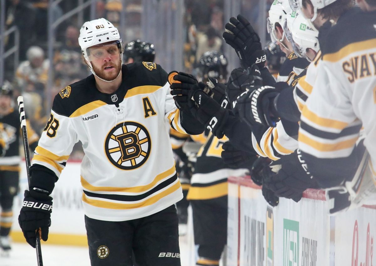 Mar 1, 2025; Pittsburgh, Pennsylvania, USA;  Boston Bruins right wing David Pastrnak (88) celebrates with the Bruins bench after scoring a goal against the Pittsburgh Penguins during the first period at PPG Paints Arena. Mandatory Credit: Charles LeClaire-Imagn Images