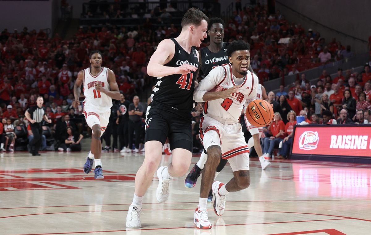 Mar 1, 2025; Houston, Texas, USA;  Houston Cougars guard Mylik Wilson (8) dribbles against Cincinnati Bearcats guard Simas Lukosius (41) in the first half at Fertitta Center. Mandatory Credit: Thomas Shea-Imagn Images